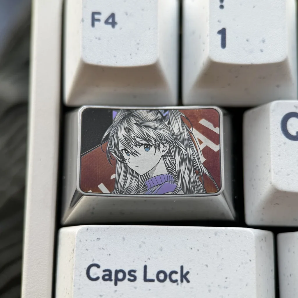 Iconic Asuka Keycap, precision engraved with bold anime art. Features metallic luster and intricate details. This premium Asuka keycap shines art design.