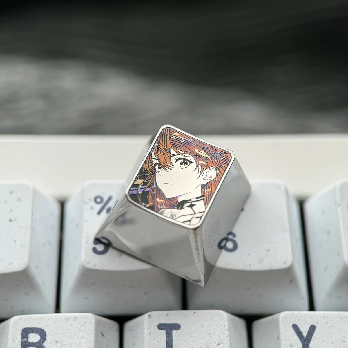 Close-up of the precision-carved Asuka ESC keycap, showcasing its intricate anime design and polished metallic finish from a side angle, a premium design.