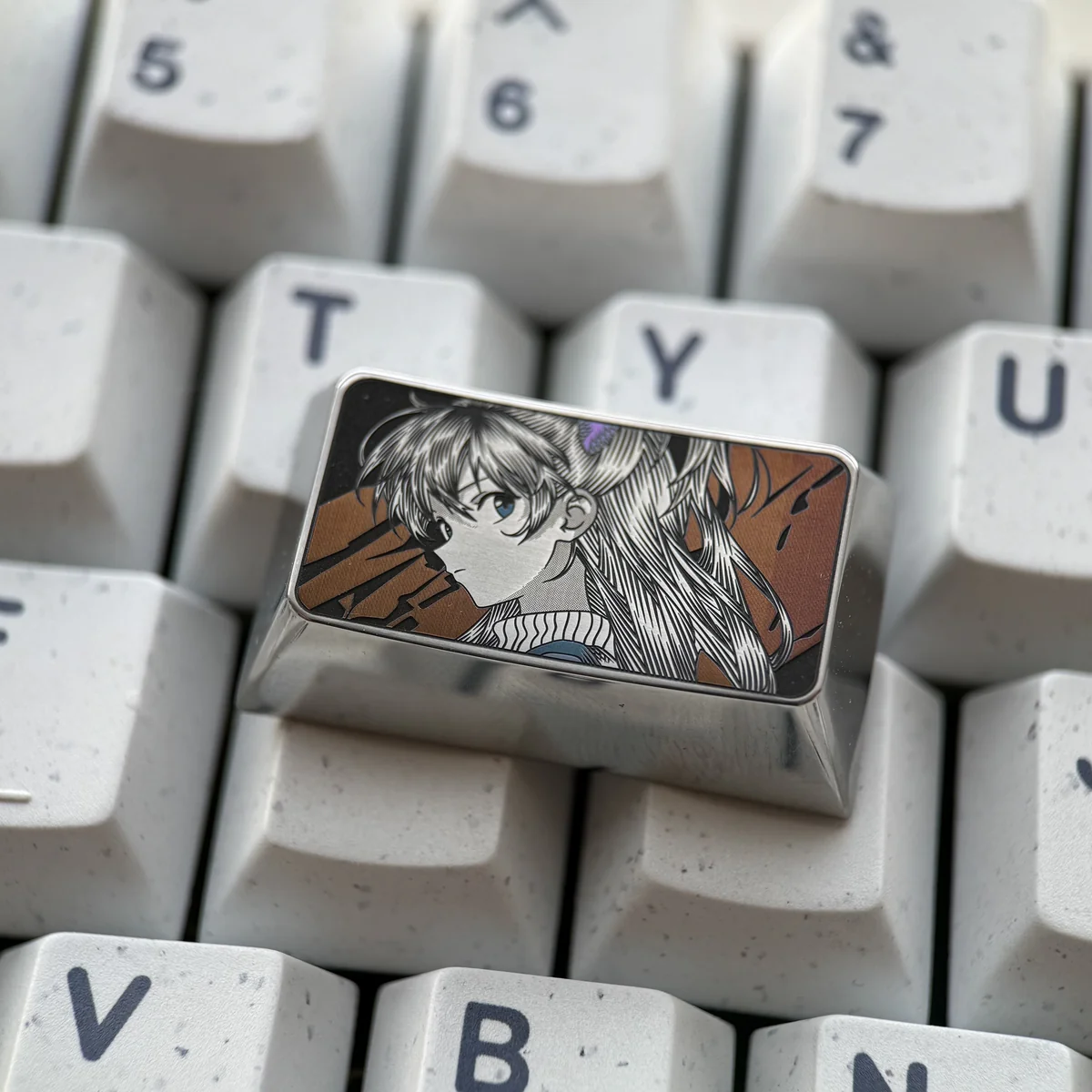 Asuka Keycap gallery: An Evangelion artisan tribute. This precision-engraved keycap reveals intricate metallic detail and the iconic character's design.