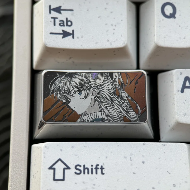 Artisan Asuka keycap inspired by Evangelion, highlighting precision-engraved metallic details and an intricate character portrait.