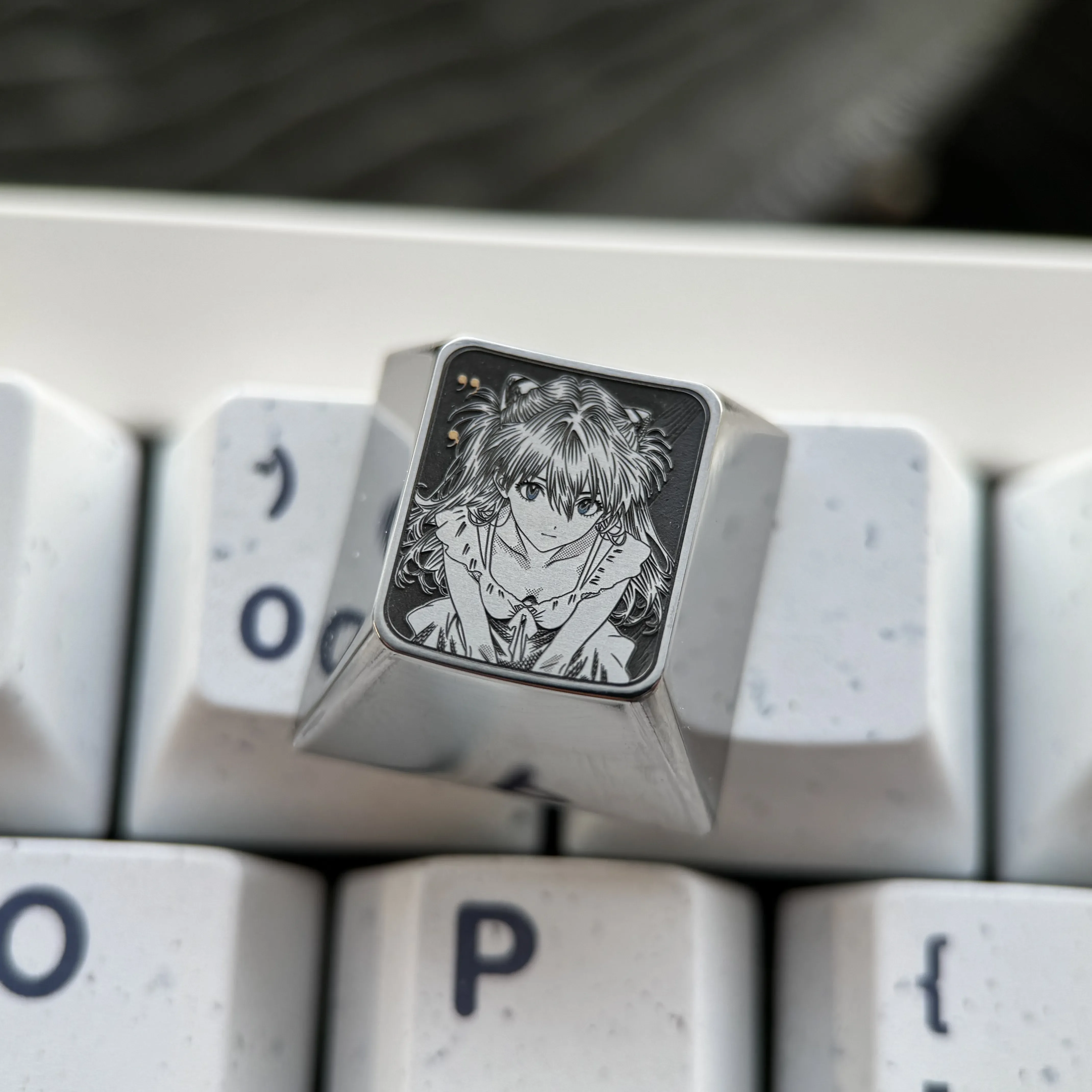 Precision-engraved Asuka titanium alloy keycaps, displaying vibrant sci-fi anime artistry and a premium metallic sheen for enthusiasts.