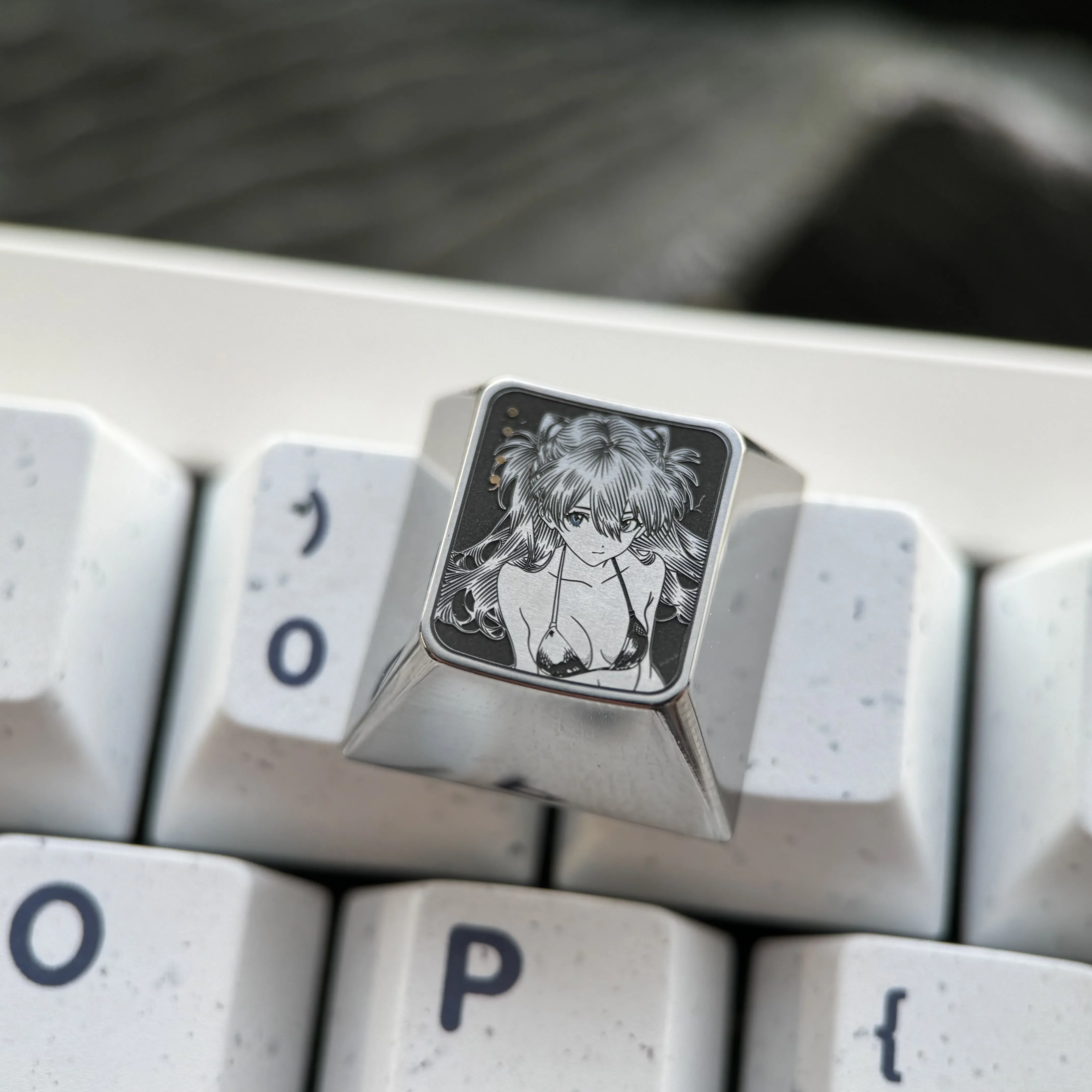 Precision-engraved Asuka titanium alloy keycaps displays vibrant sci-fi anime art and a metallic sheen, perfect for Evangelion fans.