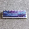 Captivating Aurora Keycaps set, showcasing frosted translucent keycaps with an ethereal light-diffusing aurora borealis glow, embodying modern design.