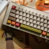 Autumn Concert Dye-sub PBT keycaps set. Views highlight warm, earthy tones, vintage instruments, forest scenes, revealing artistic quality.