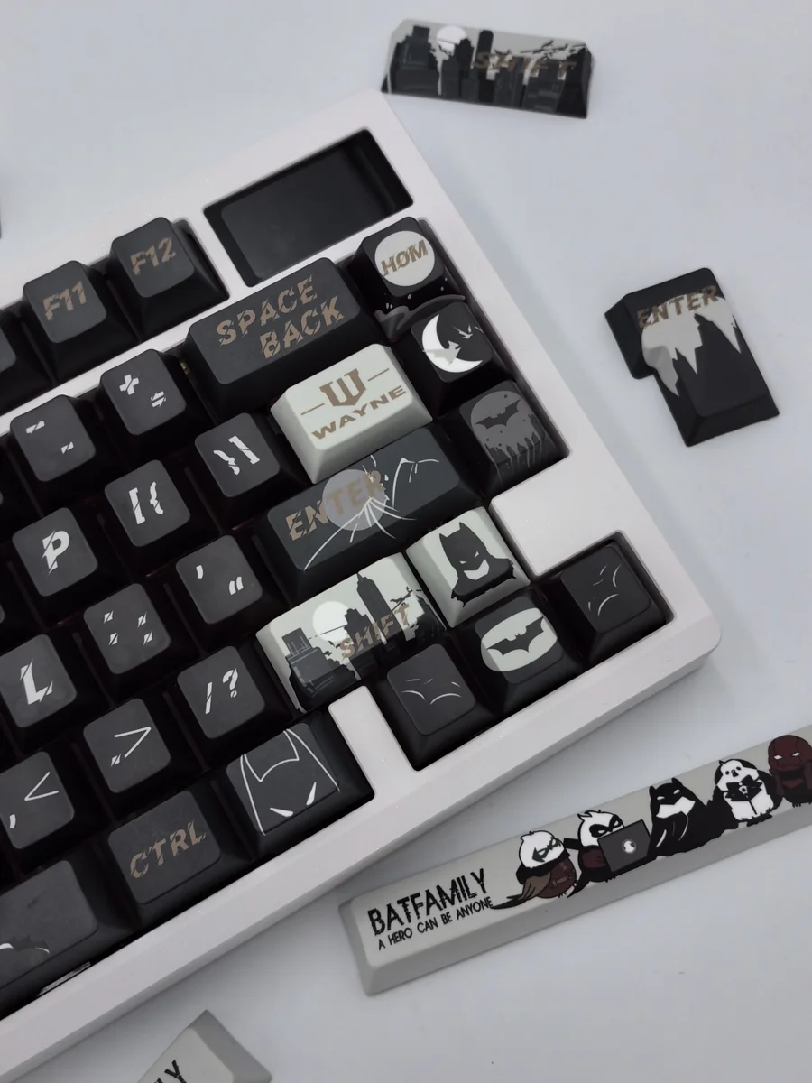 Close-up of exclusive DC Batfamily Batman keycaps from different perspectives, revealing dark, iconic designs and vibrant hero accents.
