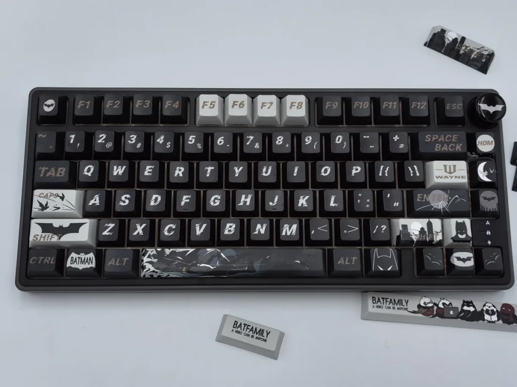 Exclusive DC Batfamily Batman keycaps set featuring iconic dark iconography with vibrant accents, showcasing this premium themed collection.
