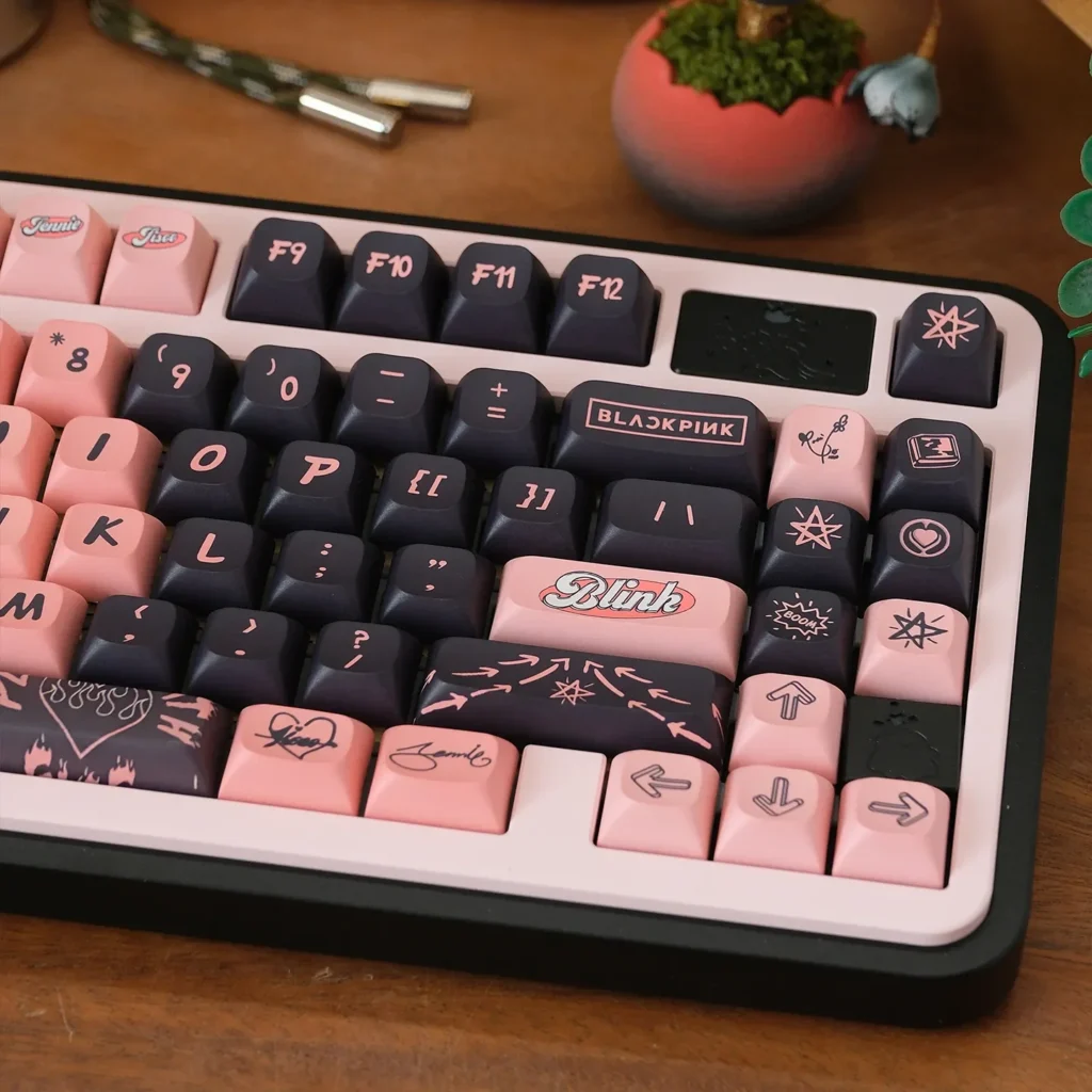 Multiple angles reveal the exclusive Black pink PBT dye-sub keycaps set, showcasing bold artistic motifs and premium custom mechanical keycap quality.