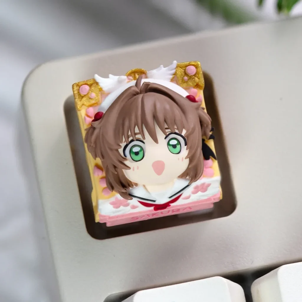 Handcrafted Cardcaptor Sakura resin keycap, with vibrant Sakura Kinomoto figurine and magical aesthetic for mechanical keyboards.