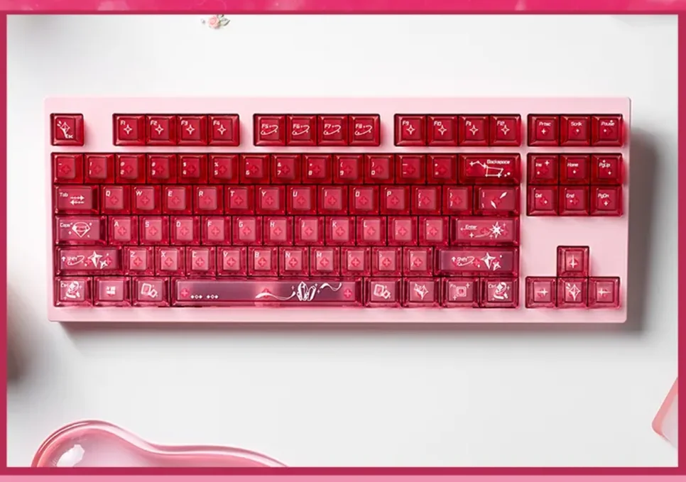A playful set of luminous transparent cinnabar pink keycap set, showcasing their delicate gradient glow on a mechanical keyboard.
