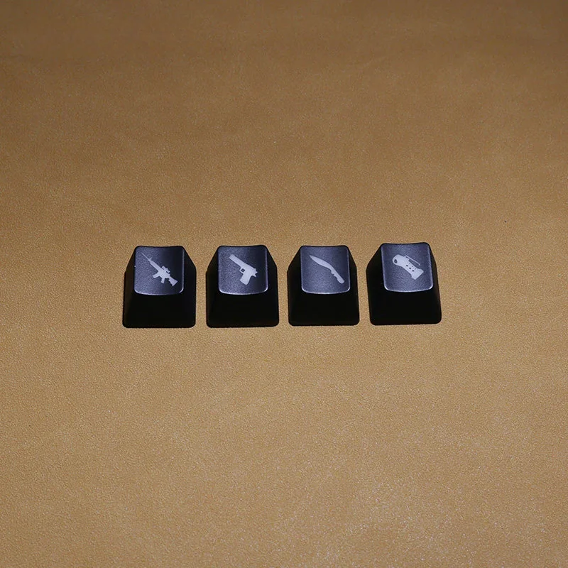 A 4-piece set of black translucent CSGO weapon switch keycaps, featuring iconic weapon silhouettes illuminated for a playful, tactical gaming setup.