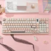 Close-up of the angelic black and pink Cupid Keycap set, showcasing unique PBT dye-sublimation with dreamy cherubs, hearts, and arrows.