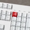 Edgy Danger Keycap with vivid 'Electric Danger' backlit warning, showcasing its high-contrast industrial design from a dynamic angle.