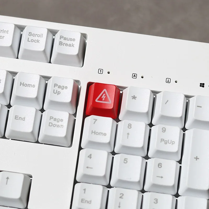 Edgy Danger Keycap with vivid 'Electric Danger' backlit warning, showcasing its high-contrast industrial design from a dynamic angle.