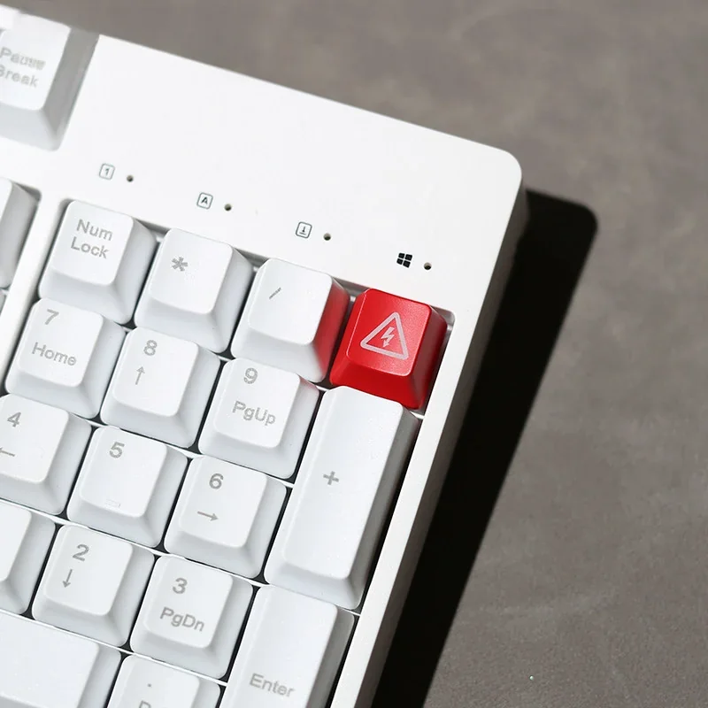 Vividly backlit 'Electric Danger' keycap, an edgy industrial warning sign for mechanical keyboards, captured from various angles.