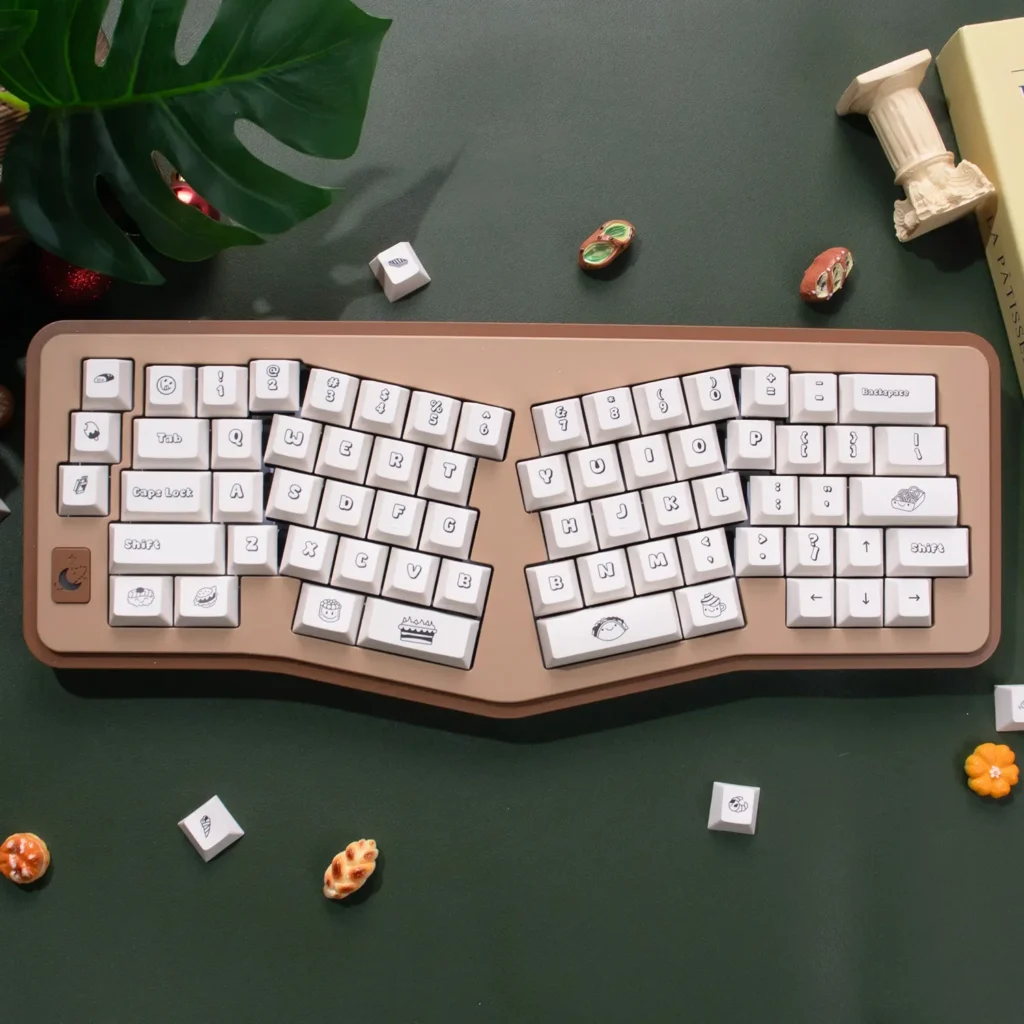Adorable PBT dye-sublimated dessert keycaps set displayed, featuring a whimsical sweet wonderland of pastel cakes, donuts, and candies.