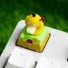 Different angles of the whimsical handcrafted Diglett & Psyduck Keycaps, emphasizing its unique resin artistry and playful rotating design.