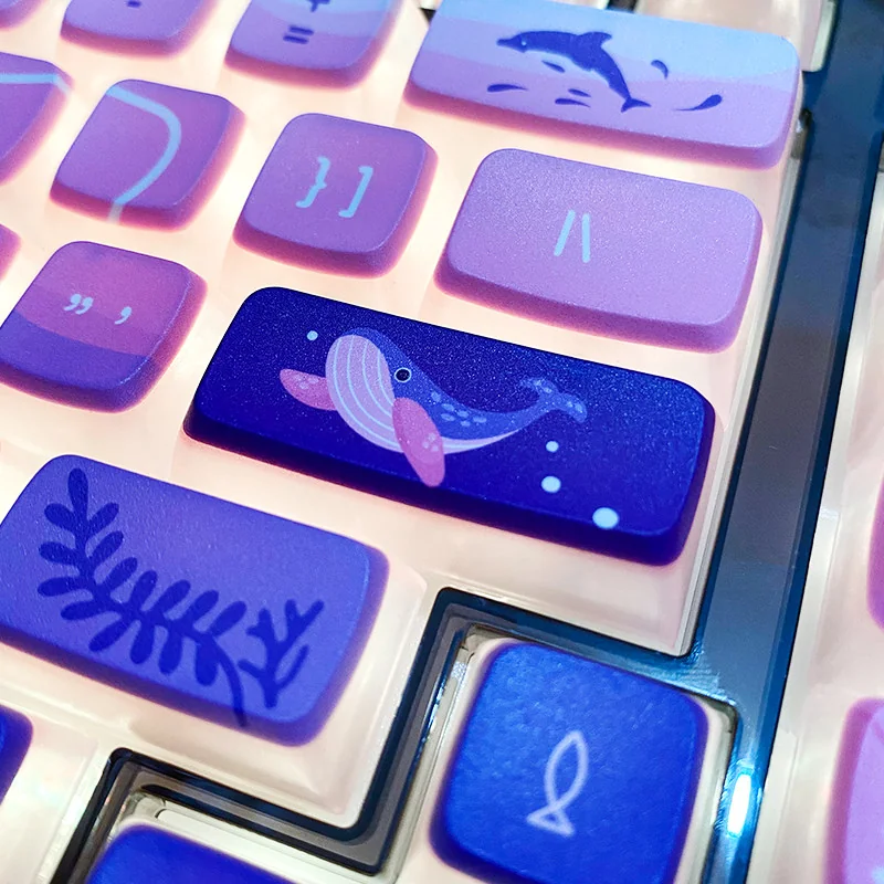A collection of luminous Dreamy Ocean Anime Pudding Keycaps Set, showcasing vibrant underwater fantasy characters and soft glowing light from various angles.