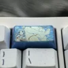 Handcrafted Frieren Keycap: a vibrant titanium 2U backspace keycap showcasing intricate Frieren anime art and exquisite elven details.