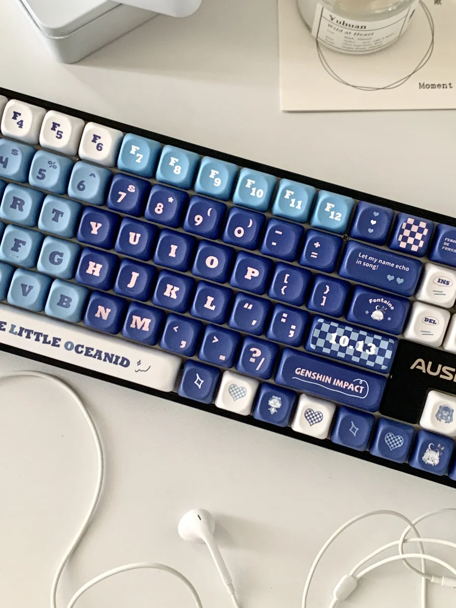 Elegant Furina PBT dye-sub keycap set, angled view showing vibrant blue, white, and gold Fontaine motifs, capturing Genshin Impact artistry.