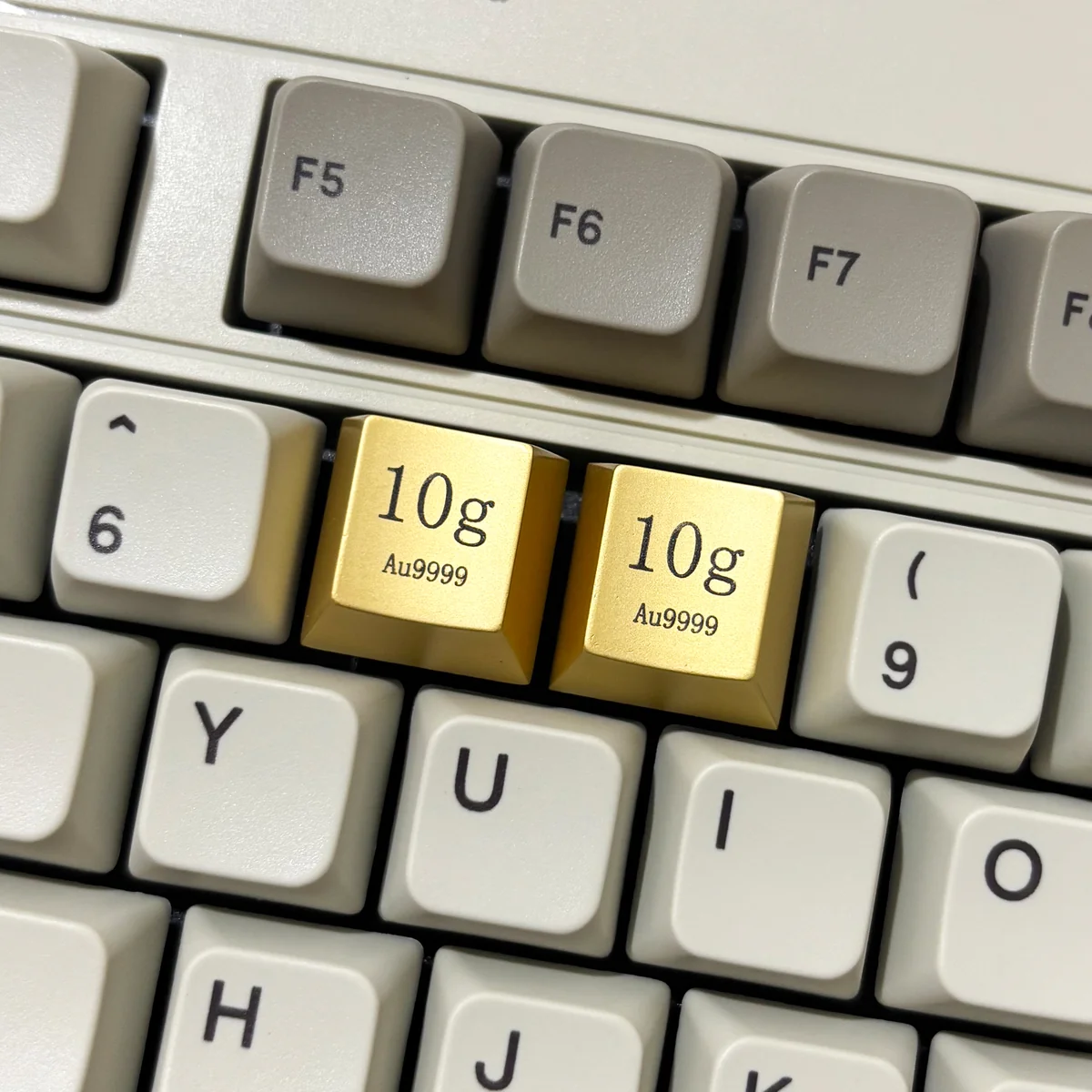 Two Premium Gold Keycaps crafted from zinc-aluminum alloy, featuring intricate laser-engraved details for a luxurious keyboard accent.