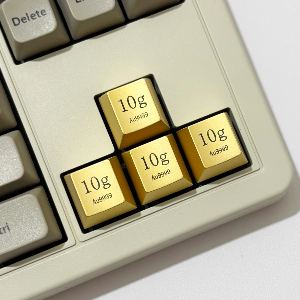 Four Premium Gold Keycaps crafted from zinc-aluminum alloy, feature an opulent electroplated finish and laser-engraved details.