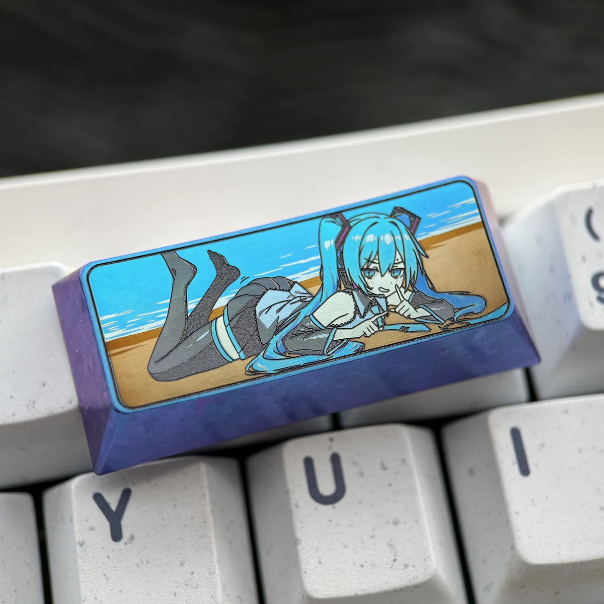 Multiple angles of a premium Hatsune Miku titanium artisan keycap, showcasing its vibrant cyber-pop design and durable anodized finish.