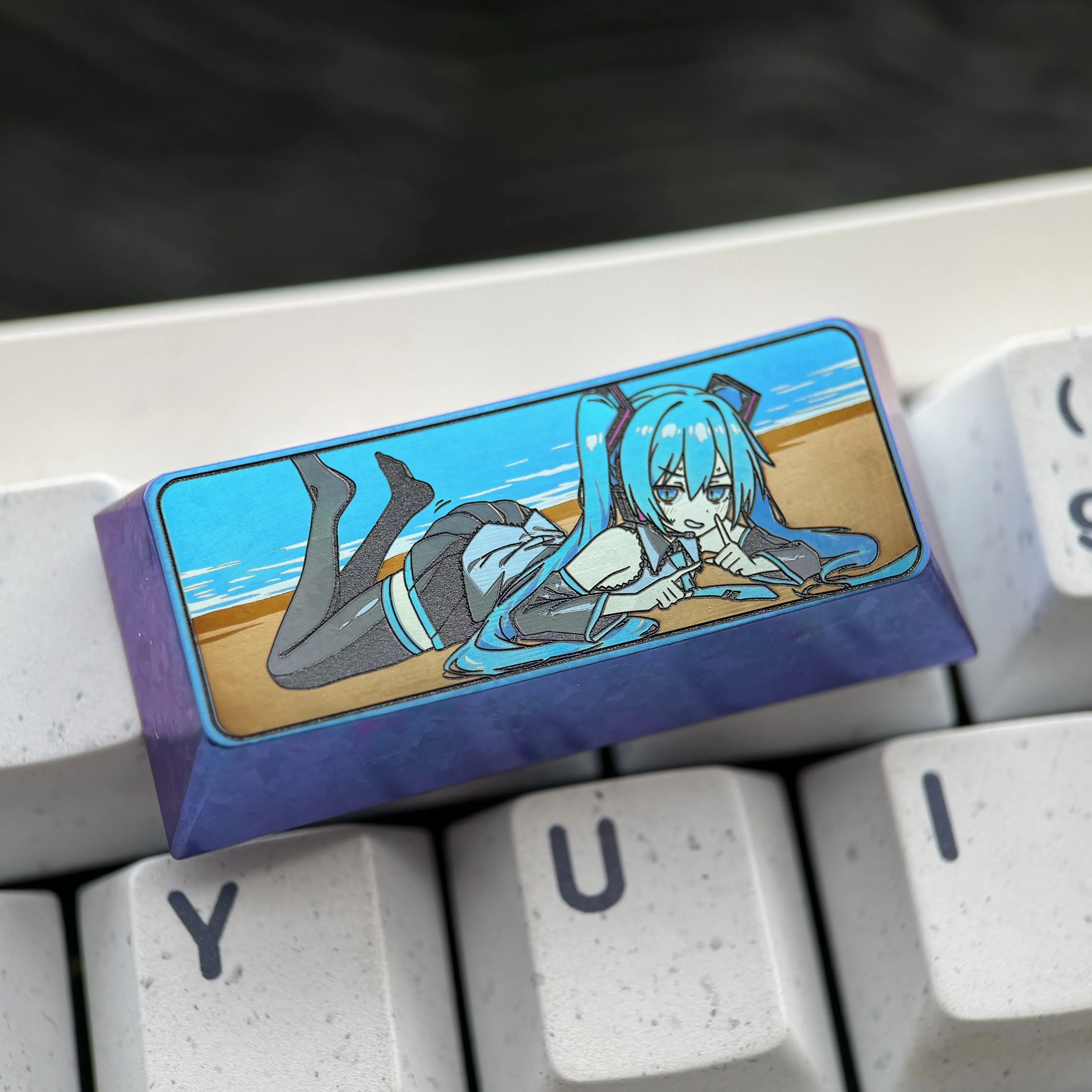 Vibrant Hatsune Miku titanium keycap, showcasing exclusive colored artistry on a 2.25U custom mechanical keyboard art piece, reflecting premium craft.