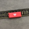Premium double-shot ABS backlit heart keycap from various angles. Reveals its sleek black/red finish, translucent glowing heart icon.