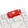 An elegant double-shot ABS heart keycap, showcasing its vibrant backlit translucent red heart icon.