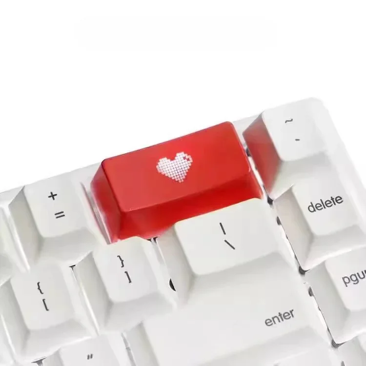 An elegant double-shot ABS heart keycap, showcasing its vibrant backlit translucent red heart icon.