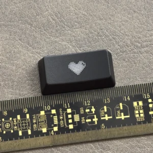 Premium black translucent double-shot ABS backspace keycap featuring a central glowing heart, designed for backlit mechanical keyboards.