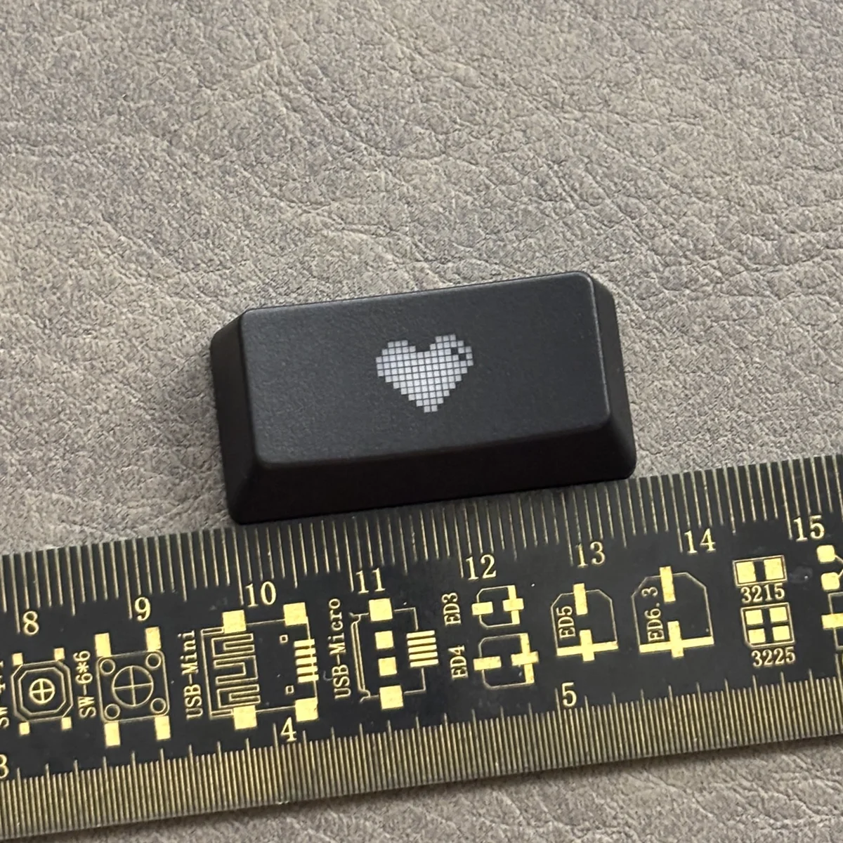 Premium black translucent double-shot ABS backspace keycap featuring a central glowing heart, designed for backlit mechanical keyboards.