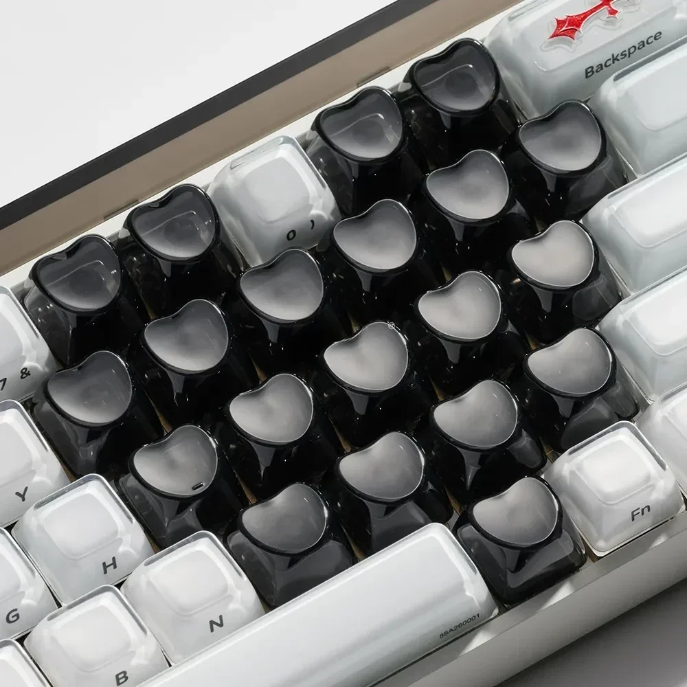 Premium transparent black luminous heart keycaps set for magnetic keyboards, showcasing their unique OEM profile and subtle RGB glow.