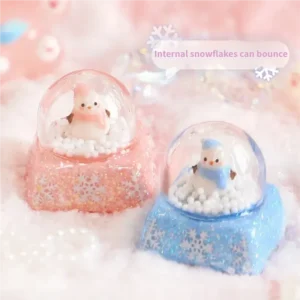 Magical Interactive Snowman Keycaps, featuring a miniature crystal ball winter scene. Press to activate the jumping blue snowman and sparkling design.