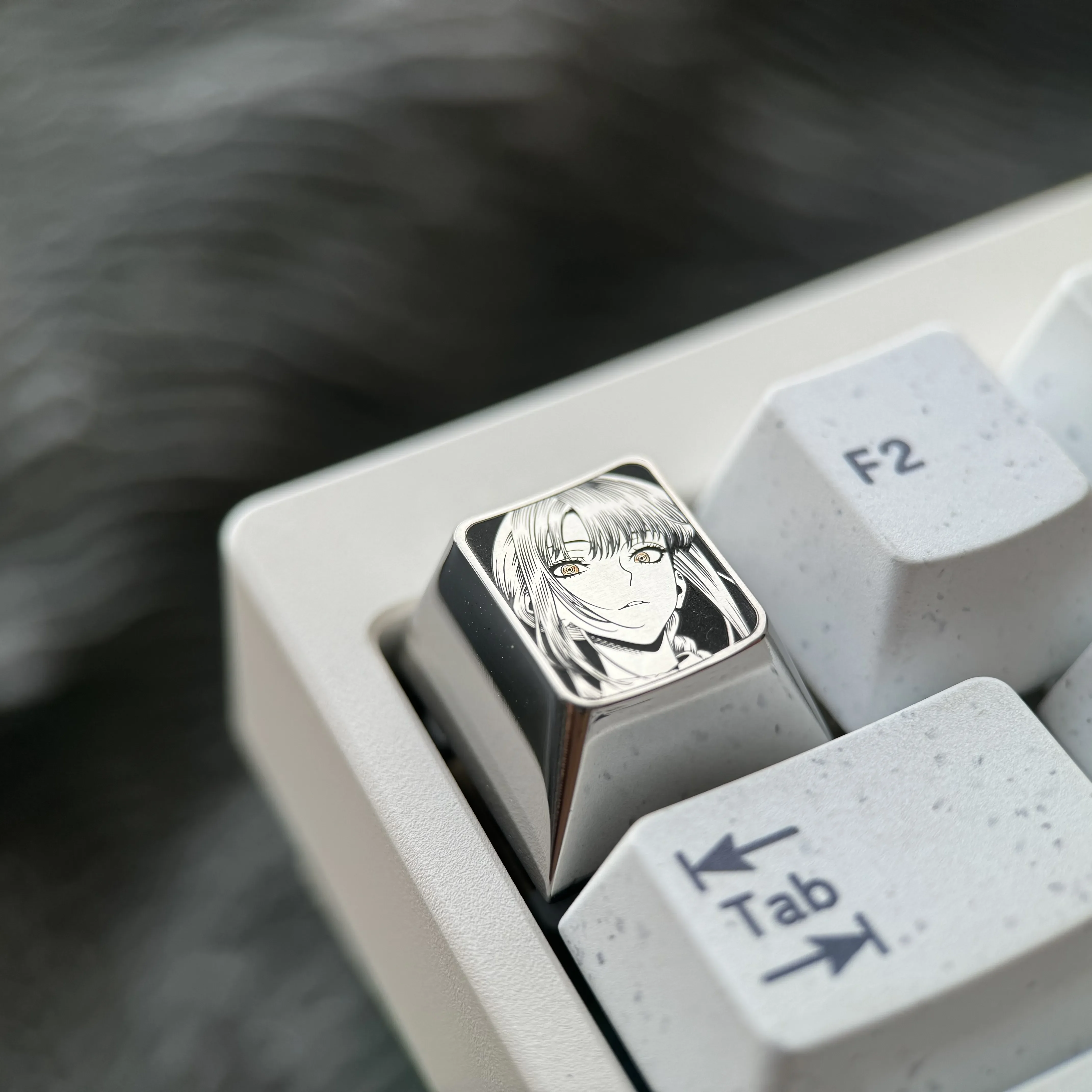 Gallery views of the premium Makima Titanium Keycap, revealing its precision-engraved Makima pointillism art on sleek silver titanium from multiple angles.