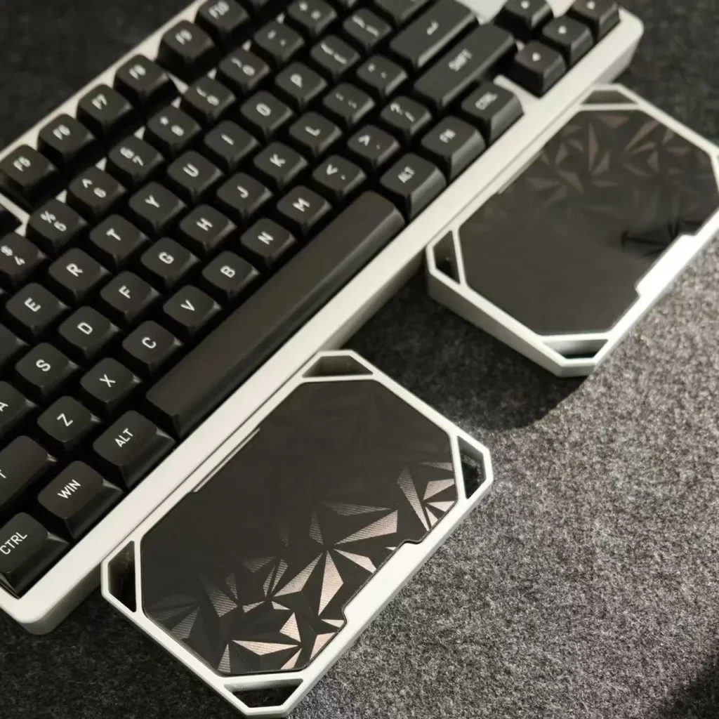 Sleek anodized black modular aluminum wrist rest for mechanical keyboards, highlighting its premium design and ergonomic split for customizable