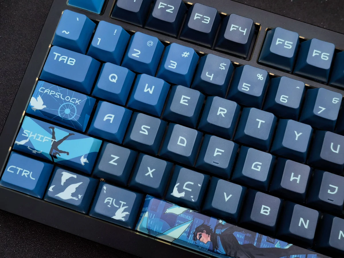 Exclusive Nightwing Spirit artisan keycap set gallery, showcasing its sleek dark blue and black finish, iconic emblem, and Cherry profile from multiple angles.