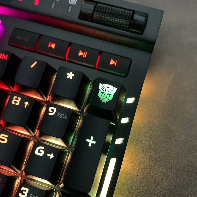 Highly detailed Optimus Prime mechanical keycap viewed from an artistic angle, emphasizing its luminous backlit design and iconic Transformers sculpt.