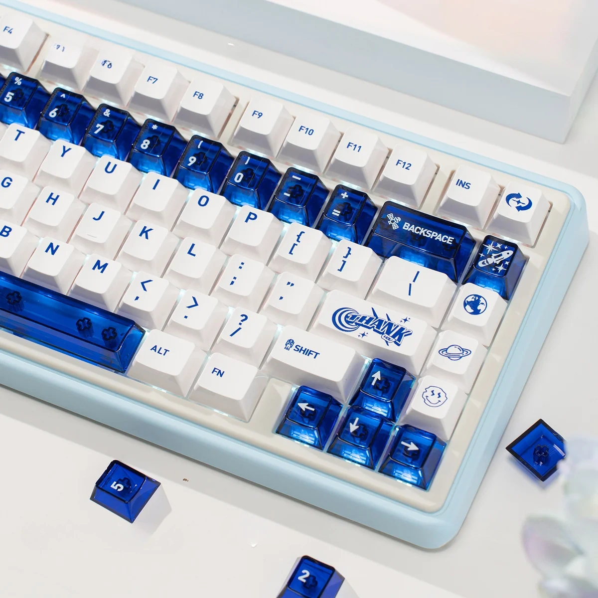 A collection of luminous ceramic-like PC keycaps se in sapphire blue and pure white, showcasing their clean, premium design from multiple angles.