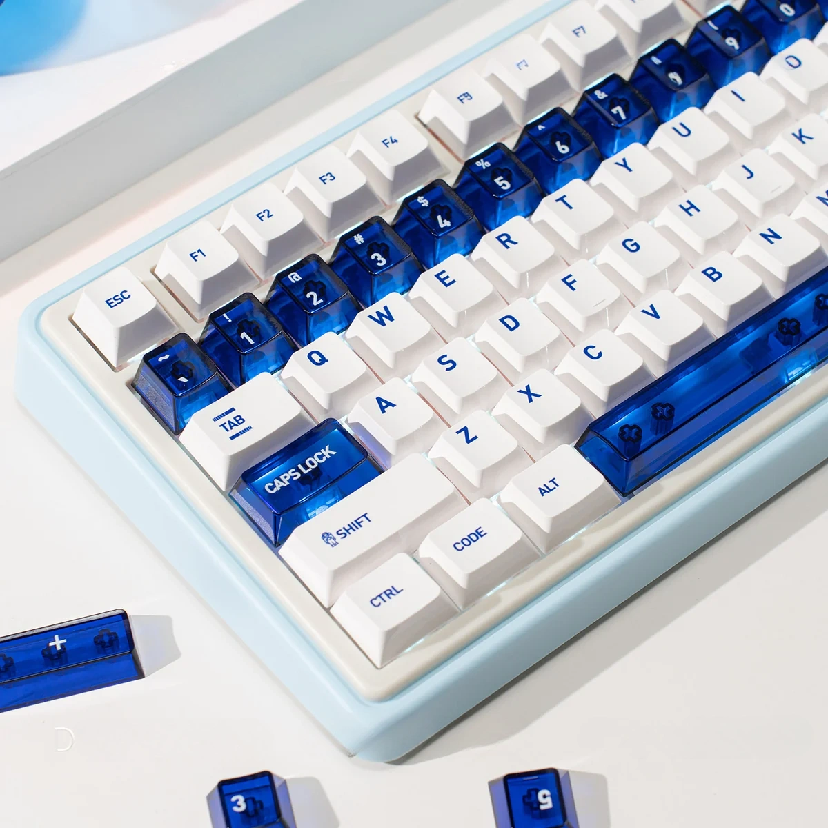 Luminous ceramic-like PC keycaps set in sapphire blue and pure white, showcased from multiple angles to highlight their premium finish and radiant glow.