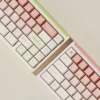 Charming soft peach pink dye-sub PBT keycaps set displayed from multiple cozy angles, highlighting their gentle aesthetic and durable quality.