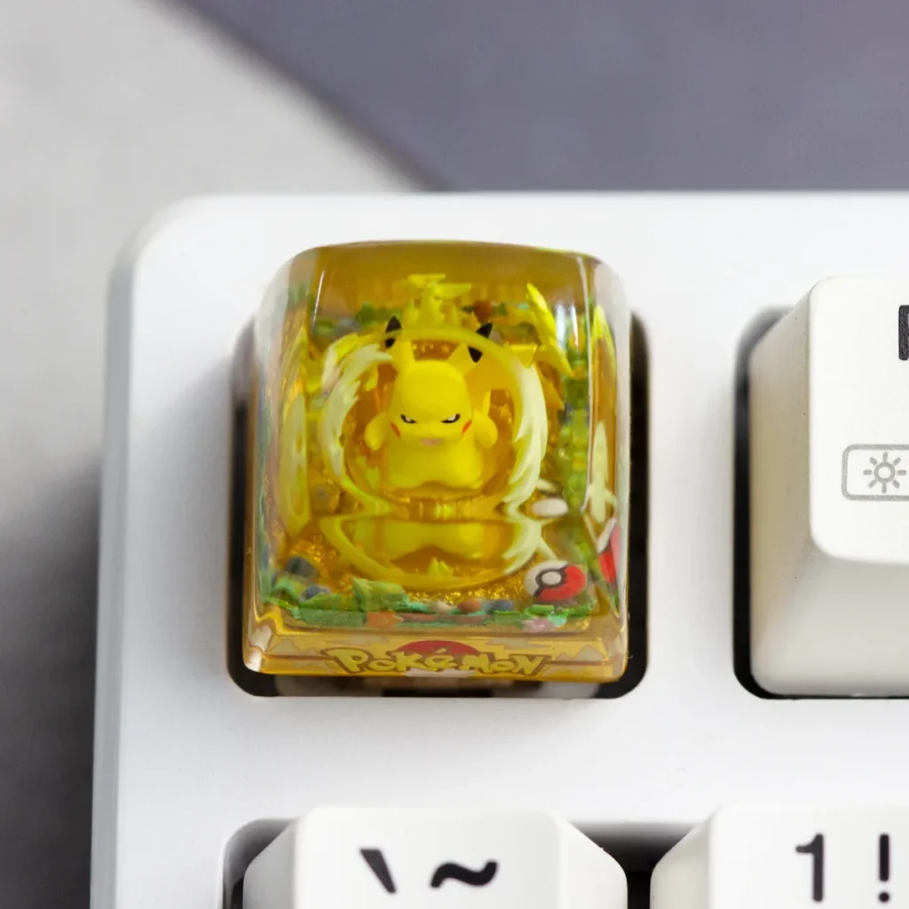 Handcrafted Pokemon: Iconic Pikachu Transparent Keycap, a vibrant resin charm for mechanical keyboards, featuring a glossy finish in a whimsical adventure theme.