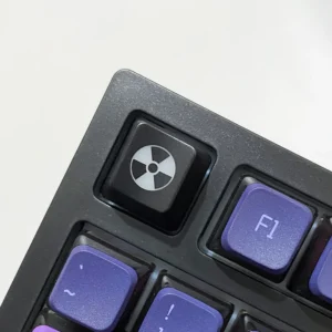 Sleek black ABS radiation keycap showcasing a vibrant, backlit nuclear hazard symbol for an edgy, distinctive custom keyboard.