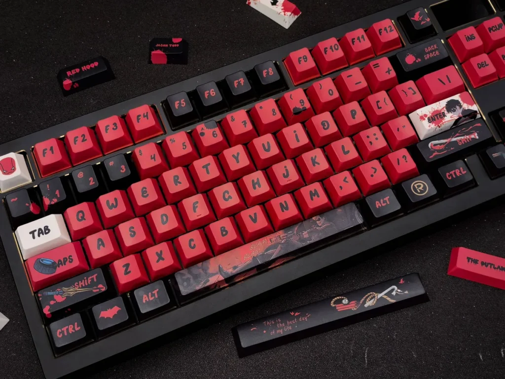 Premium Red Hood Keycaps DC Vigilante Spirit Set, featuring bold red and black iconography for a complete keyboard transformation.