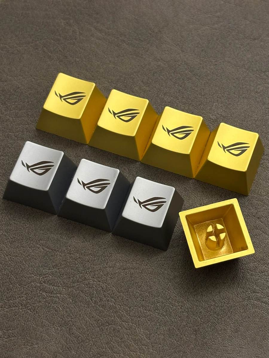 Iconic ROG Logo Alloy Keycaps displayed from multiple aggressive angles, highlighting its premium metallic finish and angular design for magnetic switch.