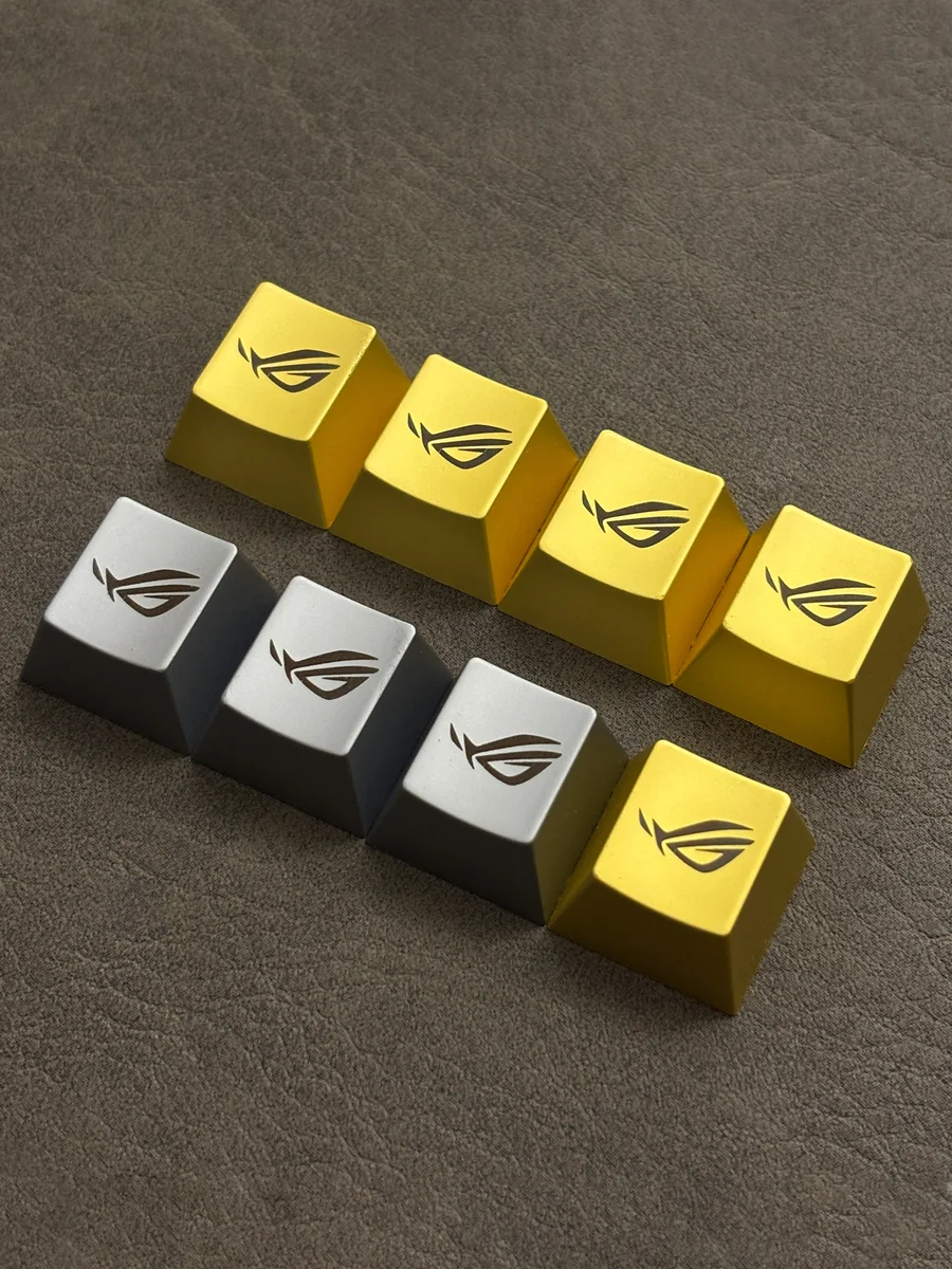 ROG Logo Alloy Keycaps from a unique angle, highlighting its aggressive angular design and premium metallic finish.