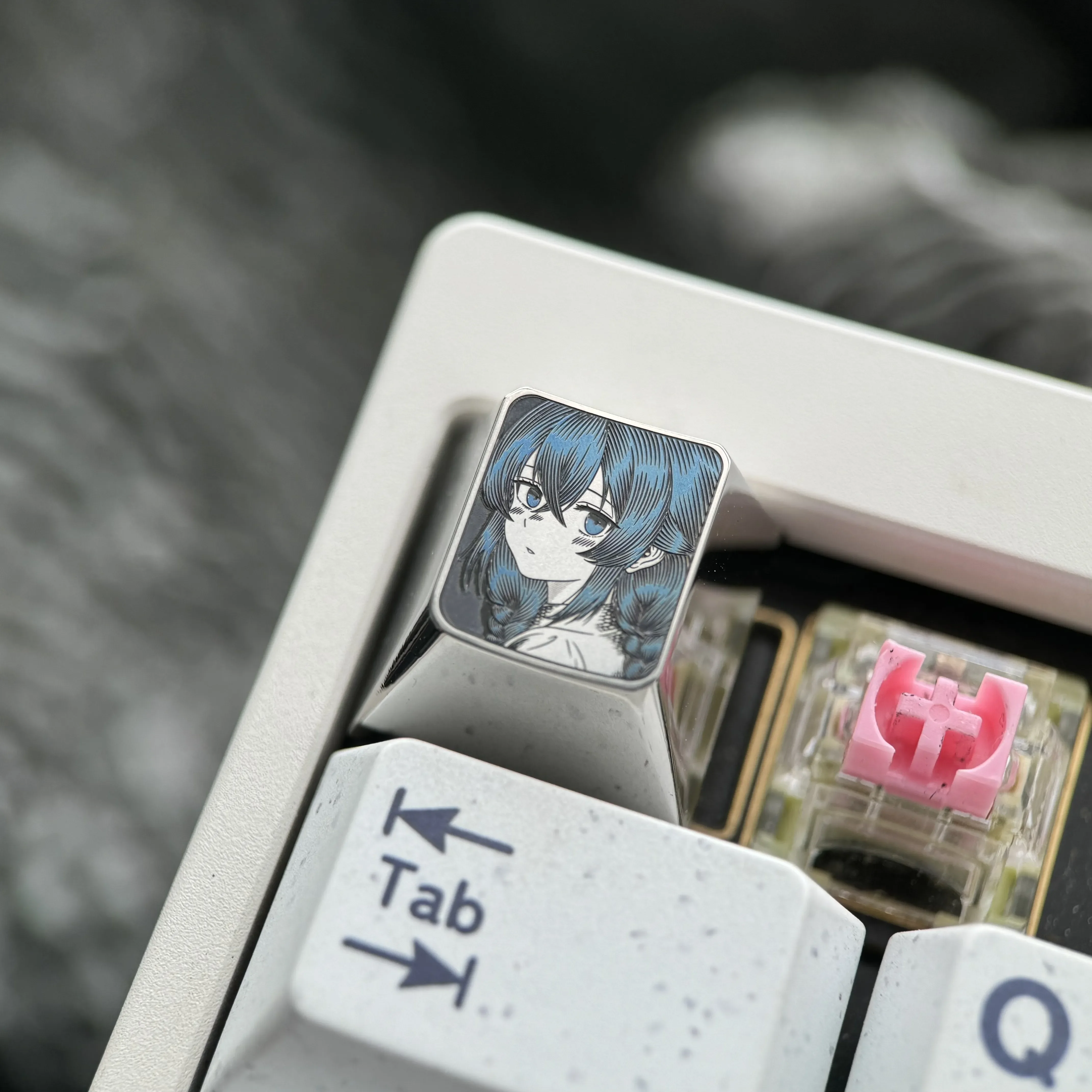 Precision-carved Roxy Titanium Keycap with intricate anime character art on polished titanium, featuring subtle silver highlights.