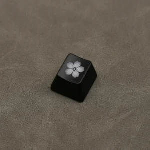 Close-up of the elegant Glowing Sakura ESC keycap, showcasing its delicate backlit cherry blossom design and premium ABS finish from a side angle.