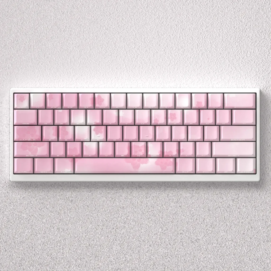 Exquisite Sakura Keycaps PBT set, side-lit with delicate pink and white cherry blossoms for mechanical keyboards.