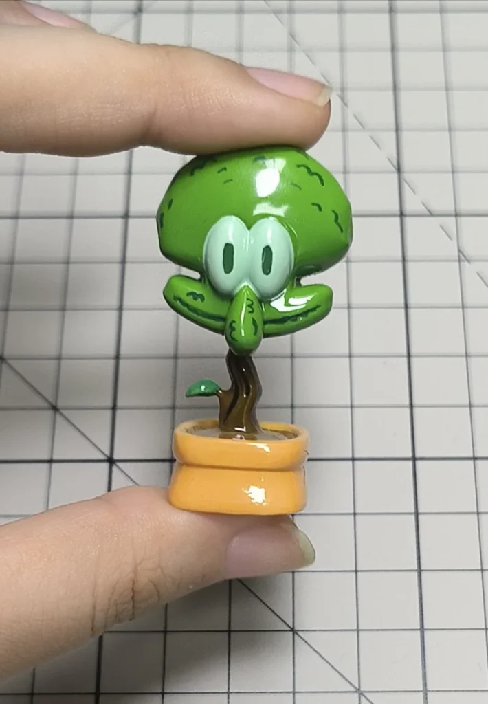 Whimsical Squidward potted plant artisan keycap, meticulously handcrafted in resin, presented from a delightful, unique perspective.